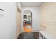 Hallway with slate tile leading to an archway into the bright kitchen at 2731 Tribble Mill Rd, Lawrenceville, GA 30045