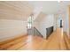 Hallway with wooden floors and ship lap accent wall leading to the staircase at 2731 Tribble Mill Rd, Lawrenceville, GA 30045