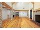 Bright living room with hardwood floors, exposed brick, and views into the modern kitchen at 2731 Tribble Mill Rd, Lawrenceville, GA 30045