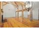 Open living room with hardwood floors, exposed beams, and chandelier at 2731 Tribble Mill Rd, Lawrenceville, GA 30045