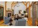 Inviting living room with vaulted ceilings, exposed wooden beams, a brick fireplace, and hardwood floors at 2731 Tribble Mill Rd, Lawrenceville, GA 30045
