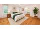 Serene main bedroom with wood floors, ensuite bathroom, and natural light from the bright windows at 2731 Tribble Mill Rd, Lawrenceville, GA 30045