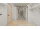 Bright, spacious walk-in closet with built-in shelving, door, and concrete flooring at 2731 Tribble Mill Rd, Lawrenceville, GA 30045