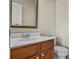 Bathroom with white sink, brown cabinets and toilet at 3058 Turman Cir, Decatur, GA 30033