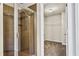 Tiled shower stall sits adjacent to an open walk-in closet with shelving at 3058 Turman Cir, Decatur, GA 30033