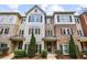 Well-manicured townhome featuring brick and siding accents, complemented by green landscaping and inviting entrance at 3058 Turman Cir, Decatur, GA 30033