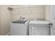 Convenient laundry room equipped with modern, white, front-loading washer and dryer at 3058 Turman Cir, Decatur, GA 30033