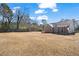 Spacious backyard showcasing the home, trees, and full-perimeter fence at 45 3Rd E Ave, Dallas, GA 30157