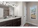 Bathroom featuring dual sinks, granite countertop, and natural light at 45 3Rd E Ave, Dallas, GA 30157