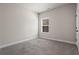 Bright bedroom featuring neutral paint, plush carpet, and natural light from a window at 45 3Rd E Ave, Dallas, GA 30157