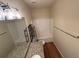 Bathroom featuring wood-look floors, granite counters, and shower-tub combo at 7843 Nolan Trl, Snellville, GA 30039