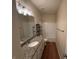 Bathroom featuring wood-look floors, granite counters, and shower-tub combo at 7843 Nolan Trl, Snellville, GA 30039