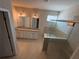 Bright bathroom featuring dual vanities and a glass shower enclosure at 7843 Nolan Trl, Snellville, GA 30039