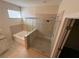 Bright bathroom featuring a tub and separate glass shower enclosure at 7843 Nolan Trl, Snellville, GA 30039