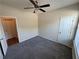 This bedroom features plush gray carpeting, a ceiling fan, and neutral paint, creating a cozy and inviting space at 7843 Nolan Trl, Snellville, GA 30039