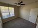 Comfortable bedroom featuring a large window and plush carpet at 7843 Nolan Trl, Snellville, GA 30039