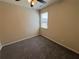 Comfortable carpeted bedroom features a ceiling fan, natural light from the window, and neutral paint at 7843 Nolan Trl, Snellville, GA 30039