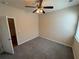 This bedroom features plush gray carpeting, a ceiling fan, and neutral paint, creating a cozy and inviting space at 7843 Nolan Trl, Snellville, GA 30039