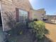 Charming home with landscaped front yard featuring lush green bushes, small flowers, and a brick facade at 7843 Nolan Trl, Snellville, GA 30039