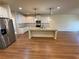 Bright kitchen features white cabinets, stainless steel appliances, granite countertops, and a spacious center island at 7843 Nolan Trl, Snellville, GA 30039