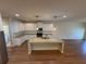Bright kitchen features white cabinets, stainless steel appliances, granite countertops, and a spacious center island at 7843 Nolan Trl, Snellville, GA 30039