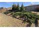 Landscaped backyard featuring lush greenery, small evergreen trees, and a wooden fence, creating a private and natural setting at 7843 Nolan Trl, Snellville, GA 30039