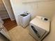 Laundry room with new washer and dryer, vinyl flooring, and overhead rack at 7843 Nolan Trl, Snellville, GA 30039