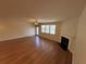 Open living room with hardwood floors, a fireplace, and a ceiling fan at 7843 Nolan Trl, Snellville, GA 30039