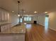 Open floor plan showcases the kitchen, living room with fireplace, and ample natural light from large windows at 7843 Nolan Trl, Snellville, GA 30039