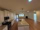 Open floor plan showcases the kitchen, living room with fireplace, and ample natural light from large windows at 7843 Nolan Trl, Snellville, GA 30039