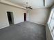 Bright main bedroom featuring plush carpet, a ceiling fan, and ample natural light at 7843 Nolan Trl, Snellville, GA 30039