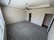 Bright main bedroom featuring plush carpet, a ceiling fan, and ample natural light at 7843 Nolan Trl, Snellville, GA 30039