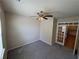 A spacious office with gray carpet, ceiling fan, and glass French doors at 7843 Nolan Trl, Snellville, GA 30039