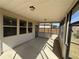 Relax in this covered screened-in porch featuring concrete floors, providing a cozy area with lighting for outdoor enjoyment at 7843 Nolan Trl, Snellville, GA 30039