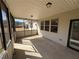 Covered screened-in porch with concrete floors offers a comfortable outdoor living space with lighting and protection from the elements at 7843 Nolan Trl, Snellville, GA 30039