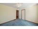 Well-lit bedroom with blue carpet and closet at 796 Marion Beavers Rd, Sharpsburg, GA 30277