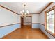 Hardwood floors, chandelier, and light blue wainscoting at 796 Marion Beavers Rd, Sharpsburg, GA 30277