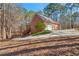 Brick house exterior with attached garage and driveway, nestled in a wooded area at 796 Marion Beavers Rd, Sharpsburg, GA 30277