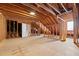 Unfinished attic with framed walls, plywood flooring, and a door at 796 Marion Beavers Rd, Sharpsburg, GA 30277