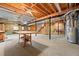 Unfinished basement with concrete floor, exposed beams, and workshop area at 796 Marion Beavers Rd, Sharpsburg, GA 30277