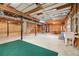Unfinished basement featuring concrete floors, exposed beams, and a garage access at 796 Marion Beavers Rd, Sharpsburg, GA 30277