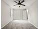Well-lit bedroom featuring neutral carpet, ceiling fan, and closet at 2777 Northwood Sw Ct, Marietta, GA 30060