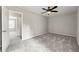 Large, open carpeted bedroom showcasing a ceiling fan and entrance at 2777 Northwood Sw Ct, Marietta, GA 30060
