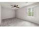 Inviting carpeted bedroom with a ceiling fan and ample natural light at 2777 Northwood Sw Ct, Marietta, GA 30060