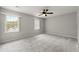 Spacious carpeted bedroom featuring a ceiling fan and bright windows at 2777 Northwood Sw Ct, Marietta, GA 30060