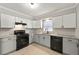 Well-lit kitchen with stainless steel appliances and granite countertops at 2777 Northwood Sw Ct, Marietta, GA 30060