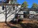 Back of house and deck surrounded by a wooded area at 683 Wood Path Ct, Stone Mountain, GA 30083