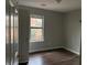 Cozy bedroom featuring hardwood floors and a window offering an outside view at 683 Wood Path Ct, Stone Mountain, GA 30083