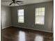 Spacious bedroom with natural light, ceiling fan, and hardwood floors at 683 Wood Path Ct, Stone Mountain, GA 30083