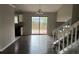 Inviting dining room with hardwood floors, sliding glass doors, and access to the staircase at 683 Wood Path Ct, Stone Mountain, GA 30083